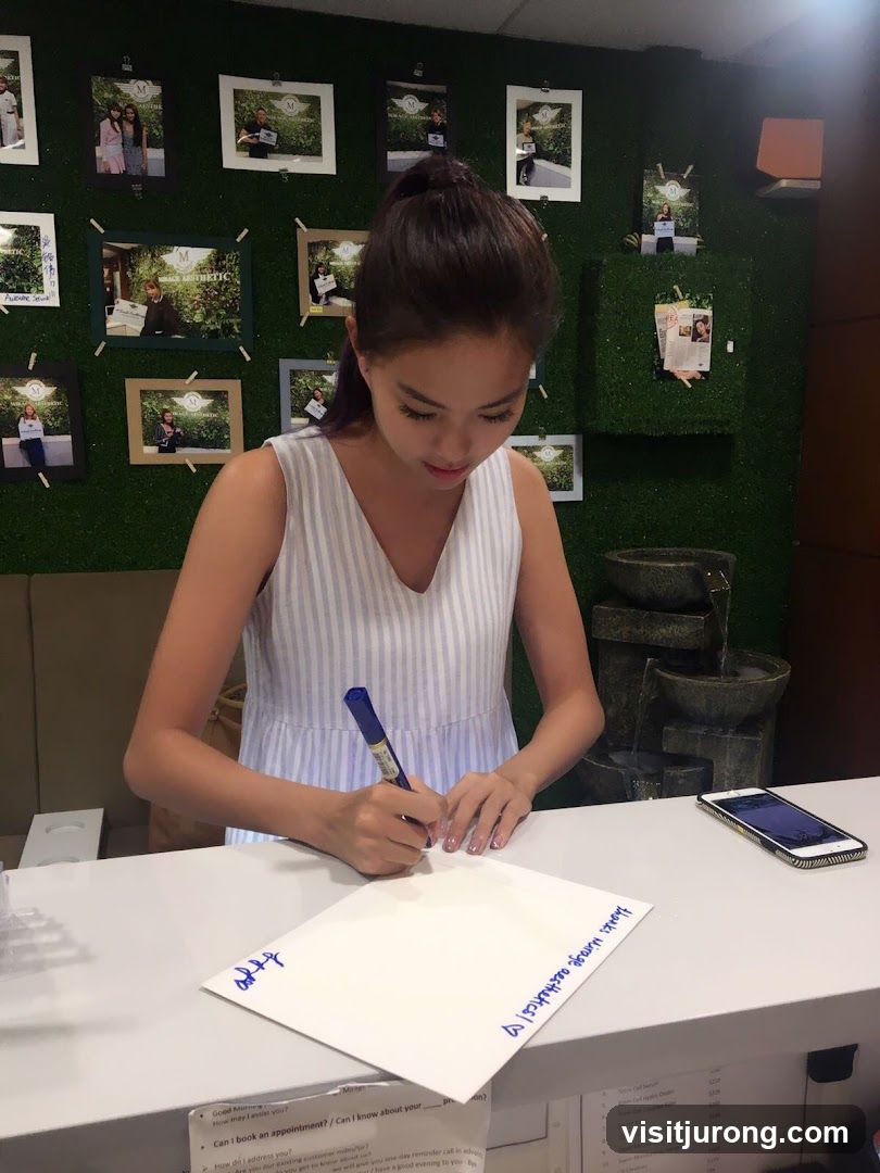 Woman filling out a form at a reception desk