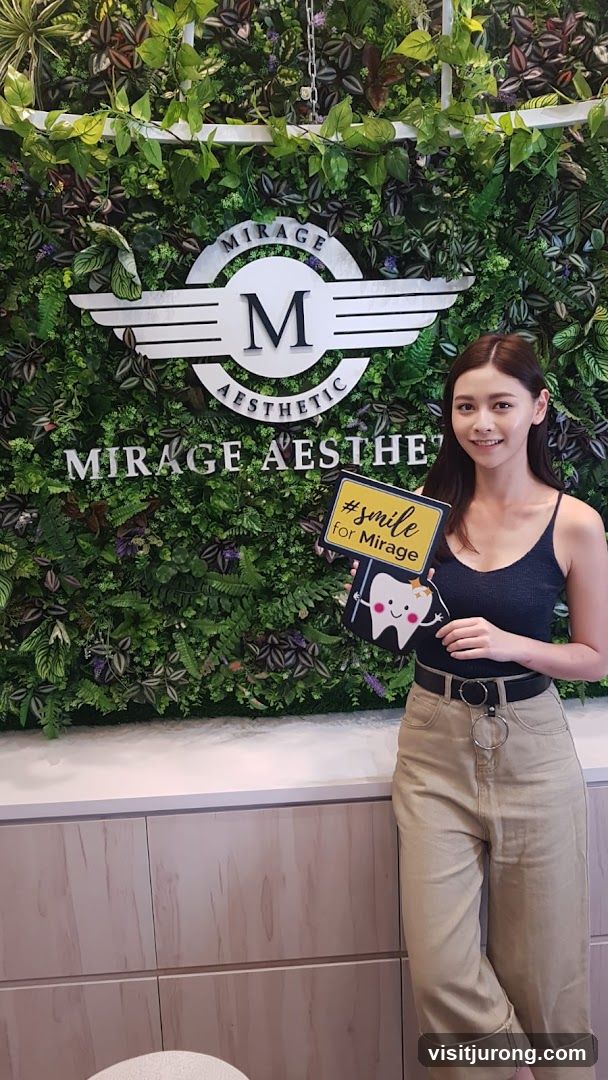 Woman holding a sign with a tooth graphic and hashtag