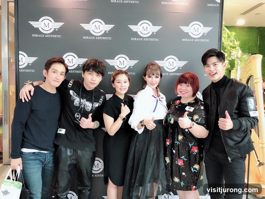 Group posing in front of a branded backdrop