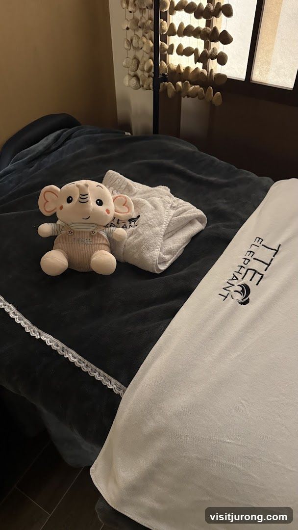 Massage table with stuffed elephant and branded towel
