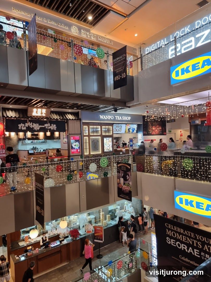 Indoor shopping mall with various food stalls and shops