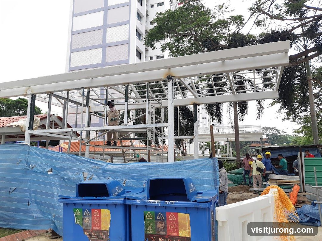 Construction Site with Workers and Recycling Bins