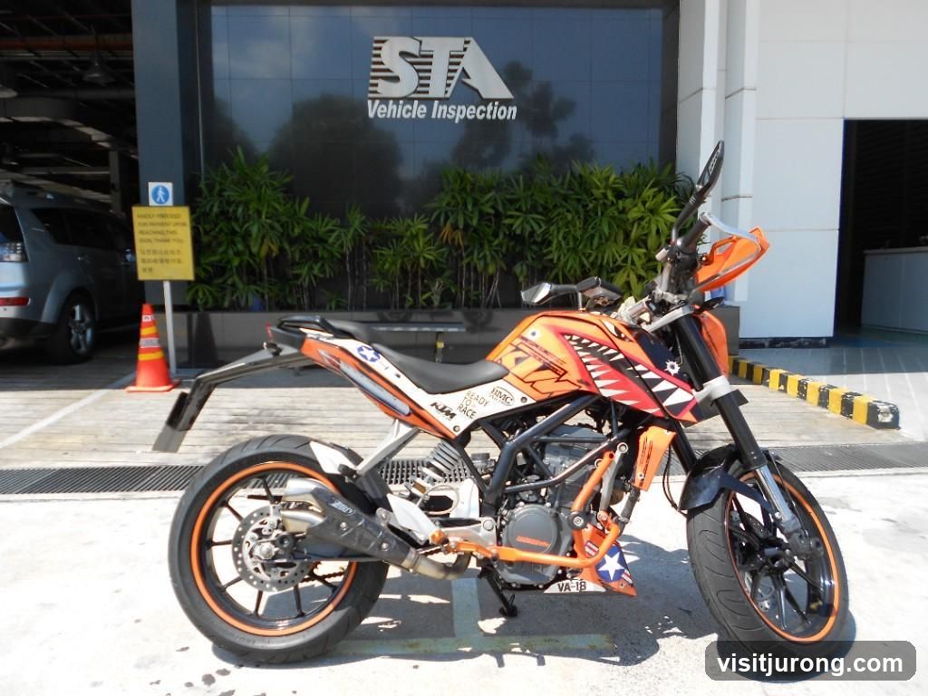 Motorcycle parked in front of a vehicle inspection building