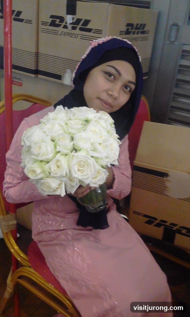 Woman holding a bouquet of white roses