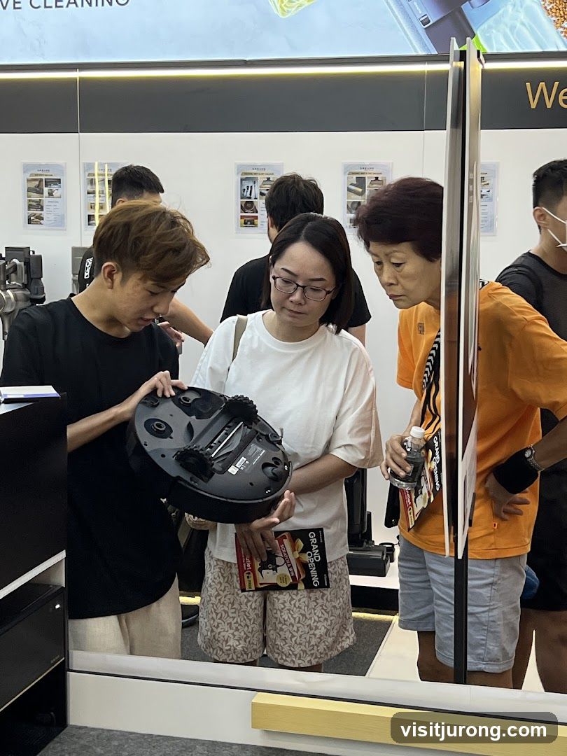 People examining a robot vacuum cleaner