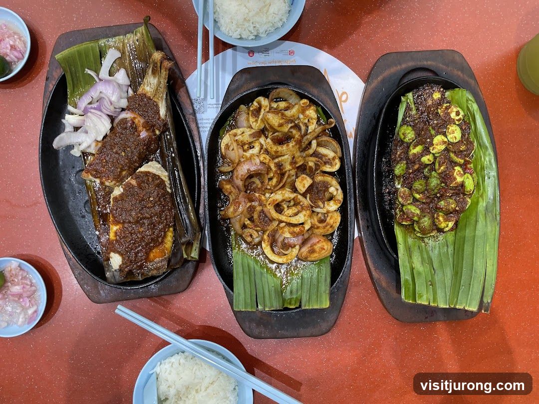 Three dishes served on banana leaves with rice