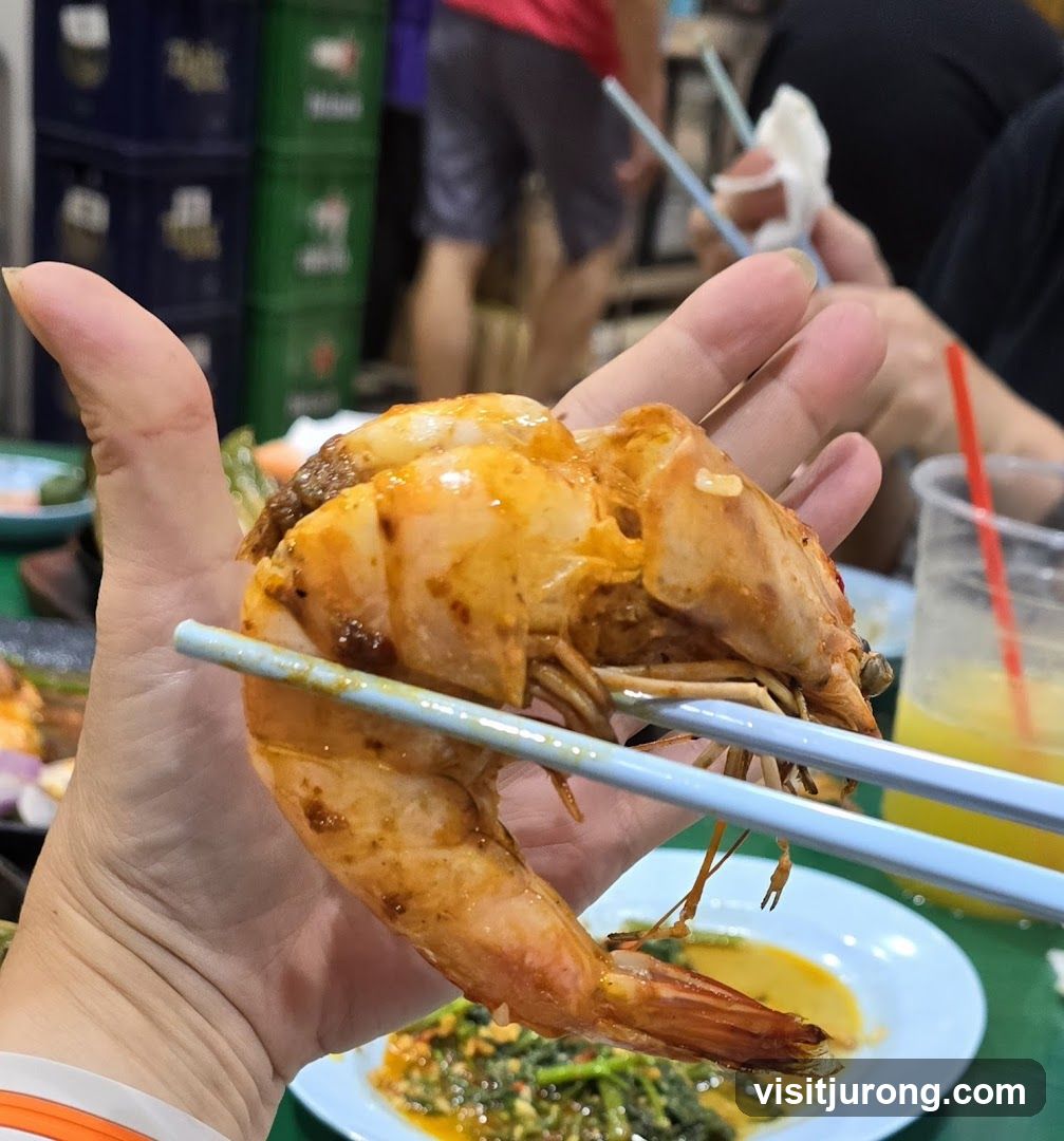 Close-up of a large prawn being held by chopsticks