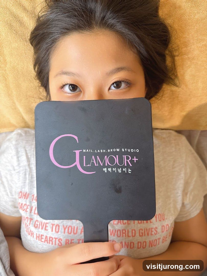 Woman holding a mirror with a salon logo