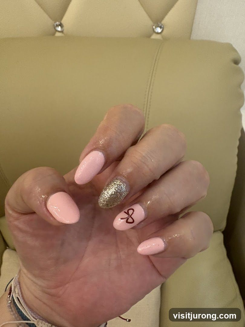 Manicured Hand with Pink and Gold Nails
