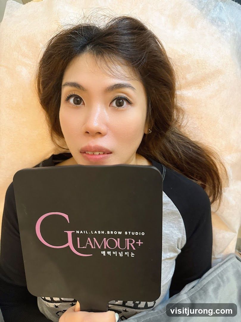 Woman holding a mirror with studio logo