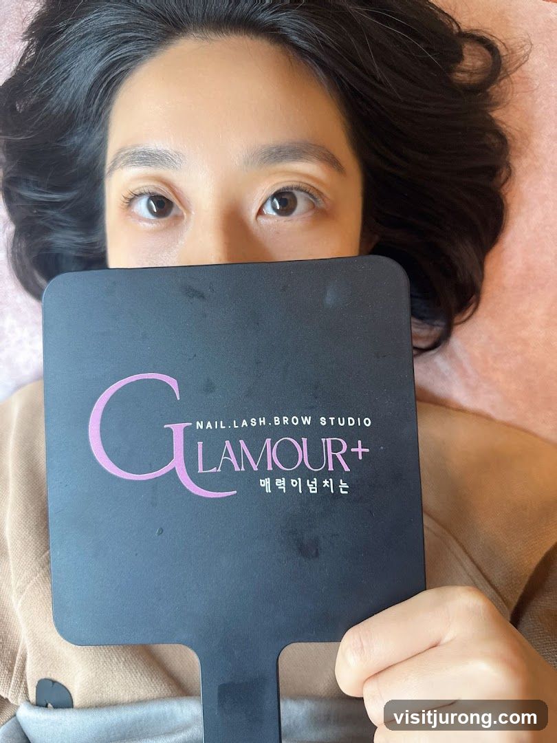 Woman holding a mirror with salon logo