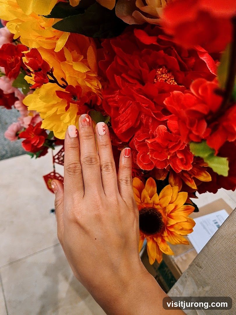 Hand with Decorated Nails and Flowers