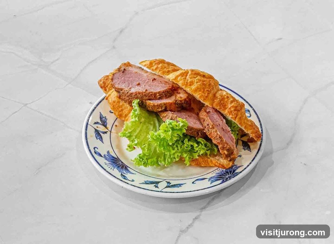 Croissant Sandwich with Sliced Meat and Lettuce