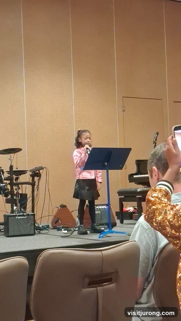 Young girl singing on stage