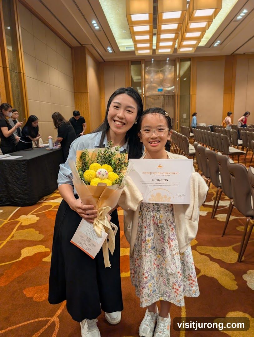 Two people holding a certificate and flowers