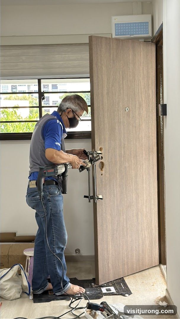 Locksmith installing a door lock