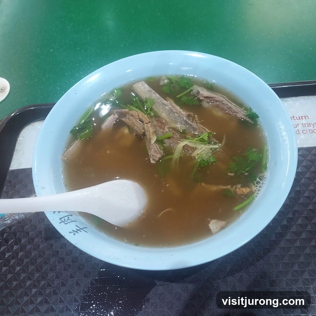 Bowl of Soup with Meat and Herbs