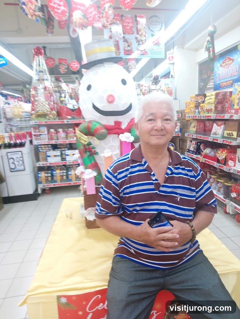 Man Poses in Front of Christmas Display