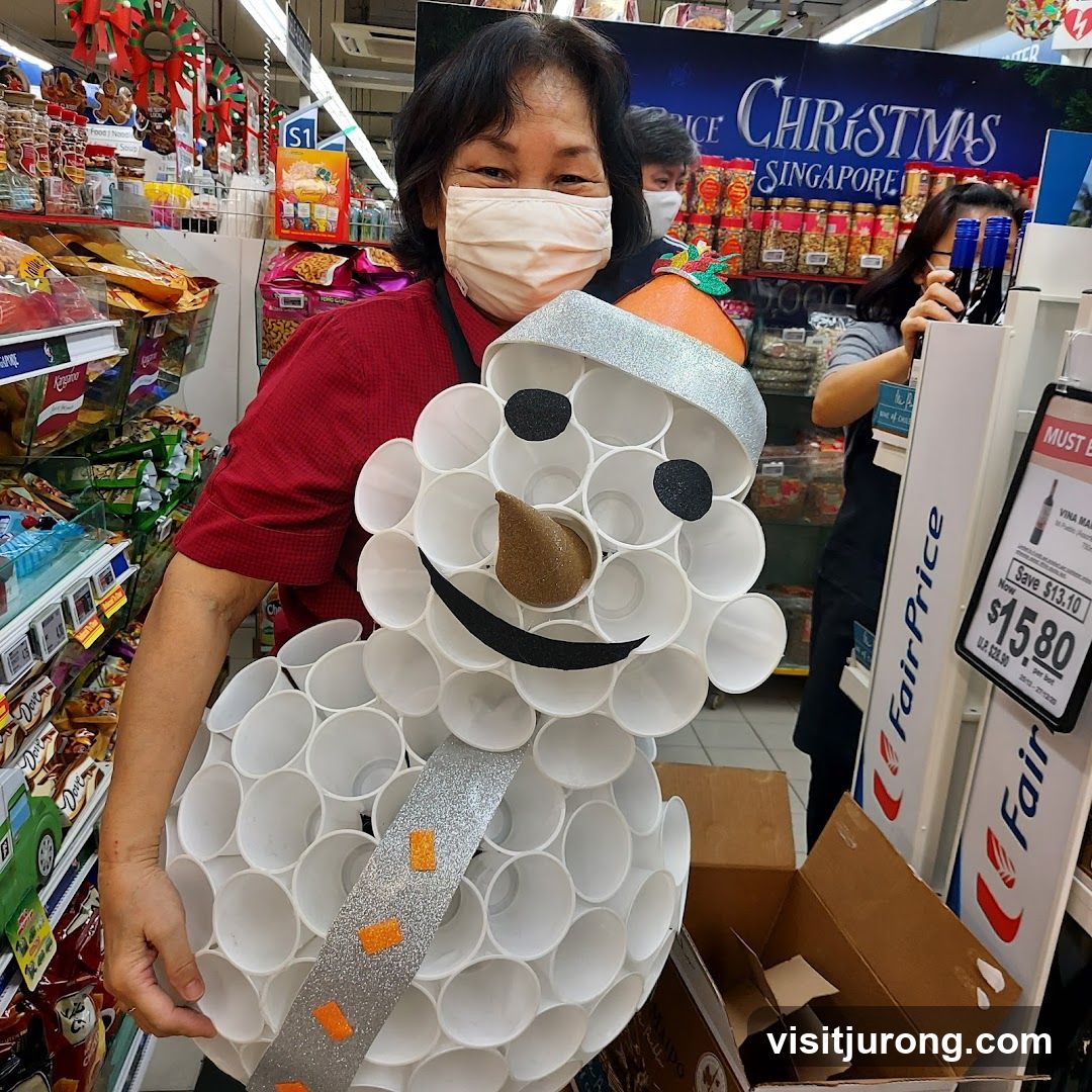 Woman holding a snowman decoration in a supermarket