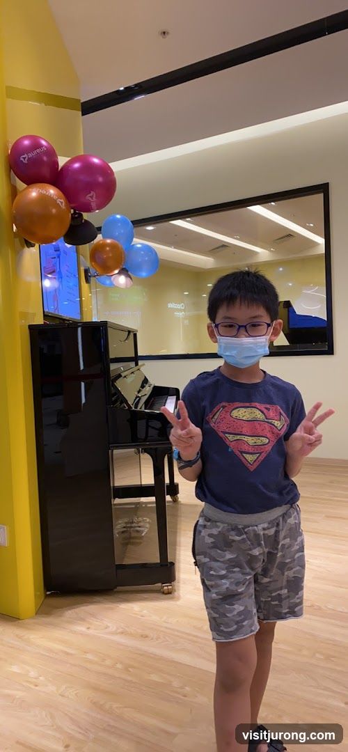Boy in Superman shirt with balloons
