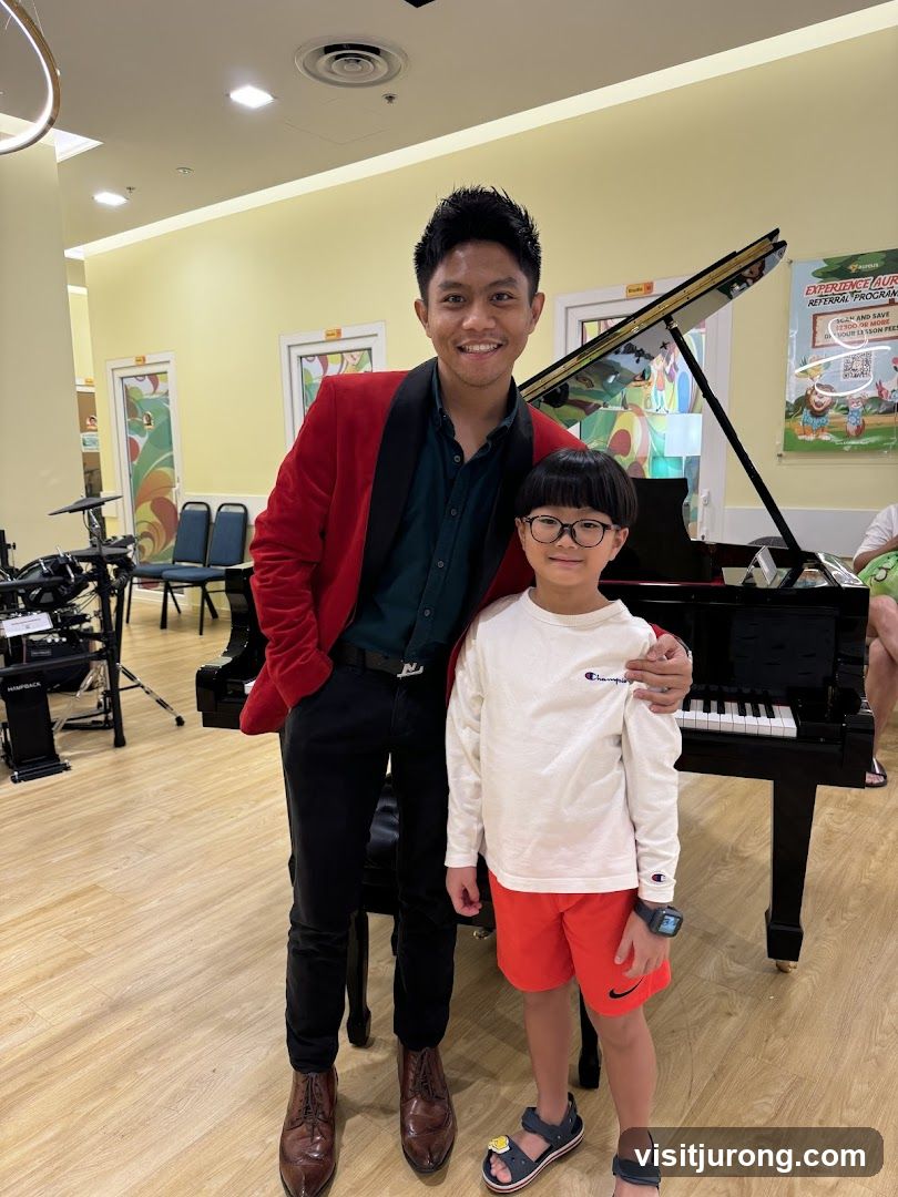 Man and boy posing by a piano