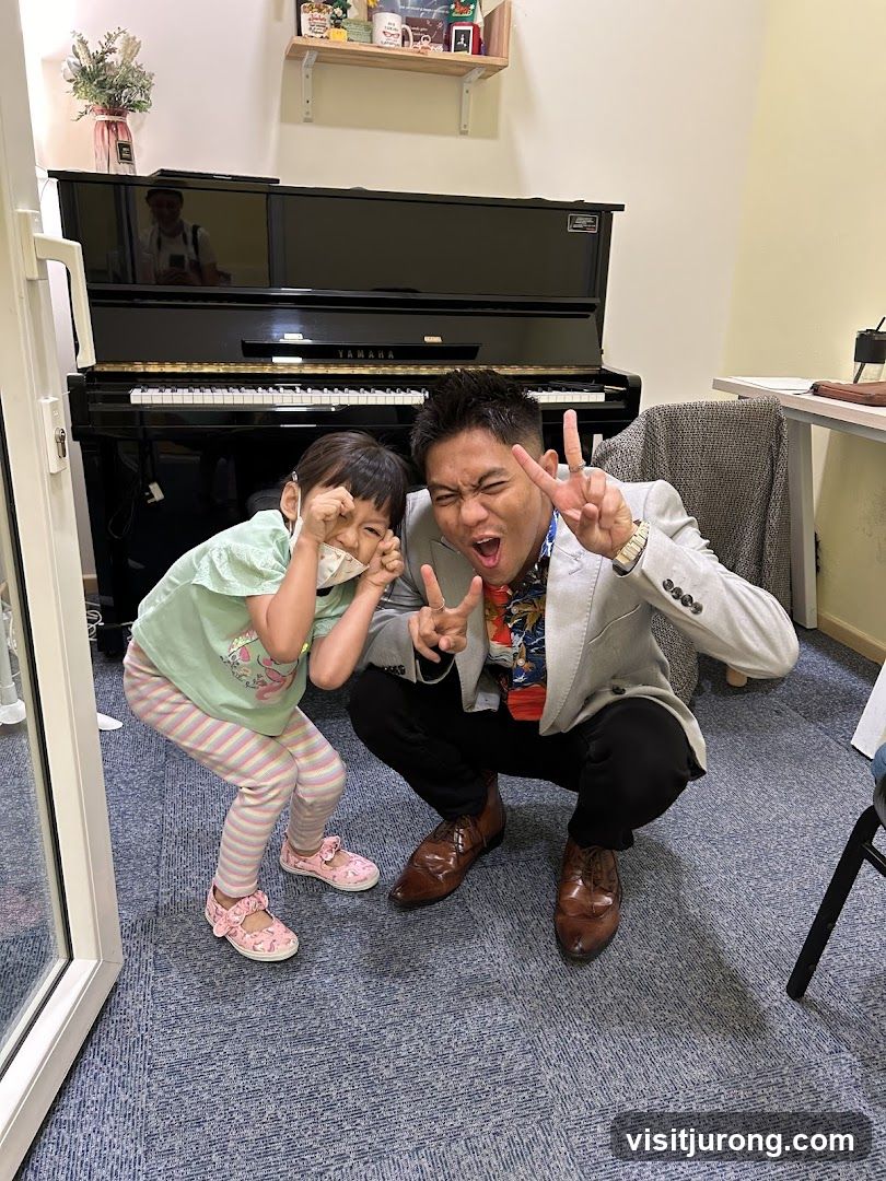 Man and child posing in front of a piano