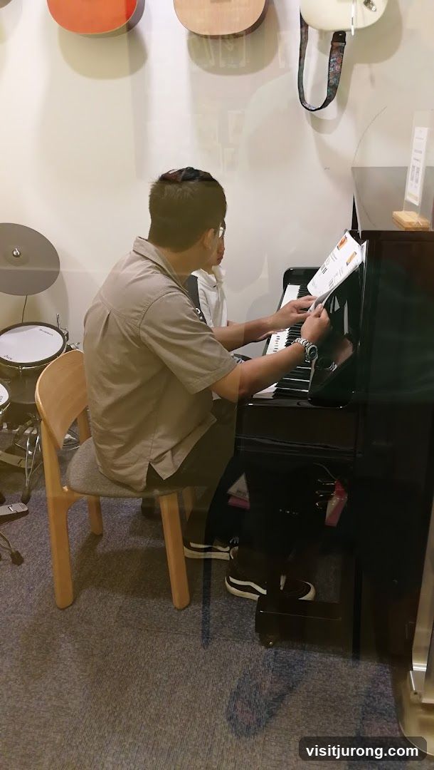 Person playing piano in music store