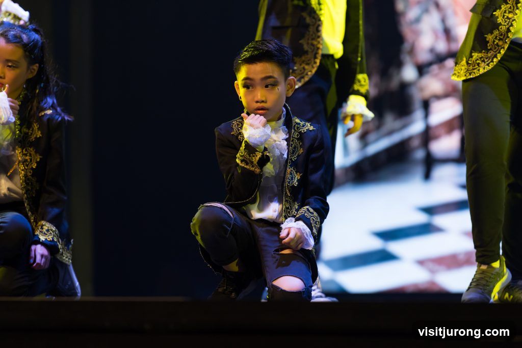 Children in ornate costumes on stage