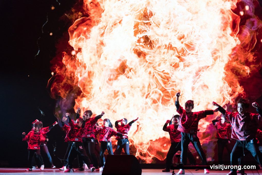 Children Dancing in Front of Fiery Background