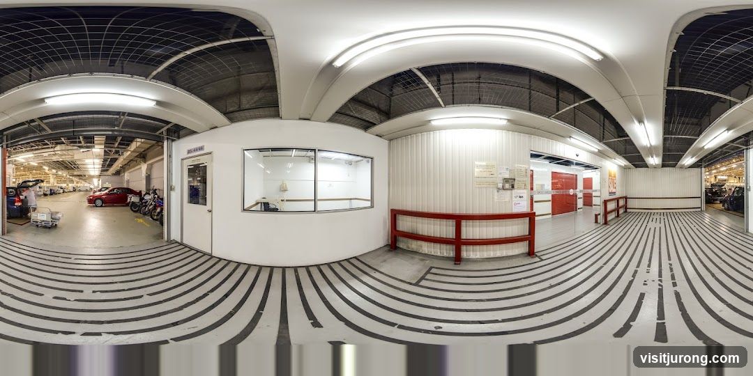 Interior of a large facility with cars and motorcycles