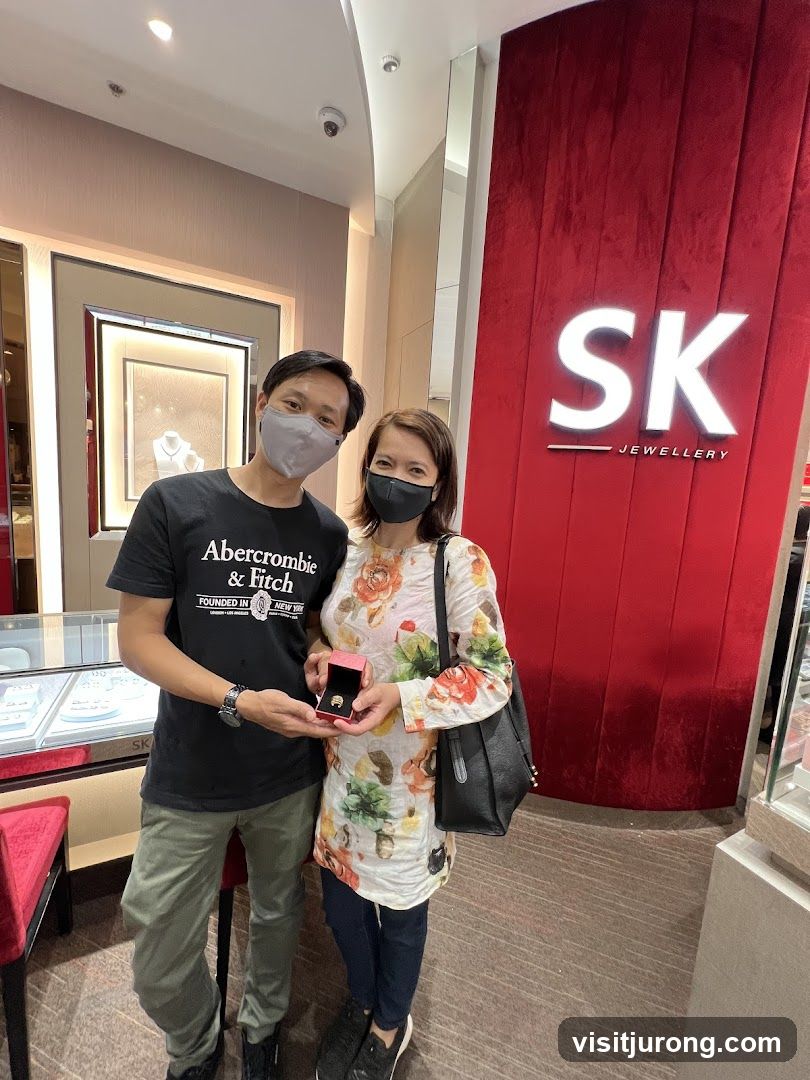 Couple holding a ring box in a jewelry store