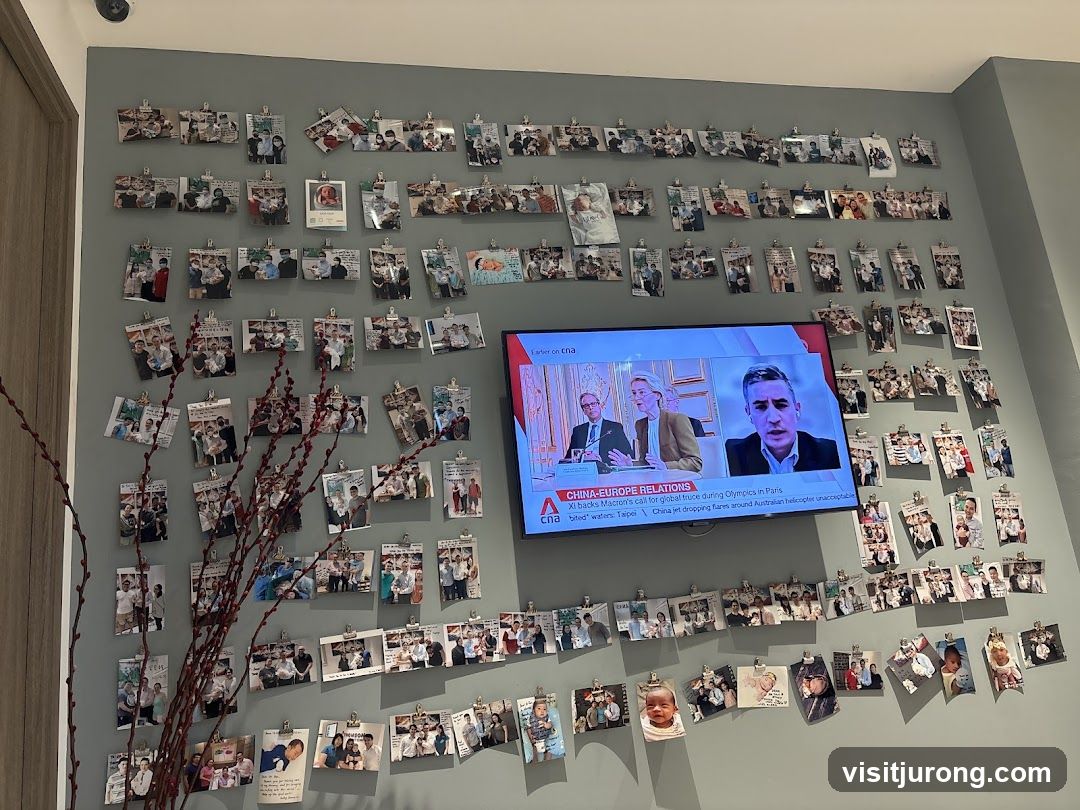 Wall decorated with photos and a TV screen