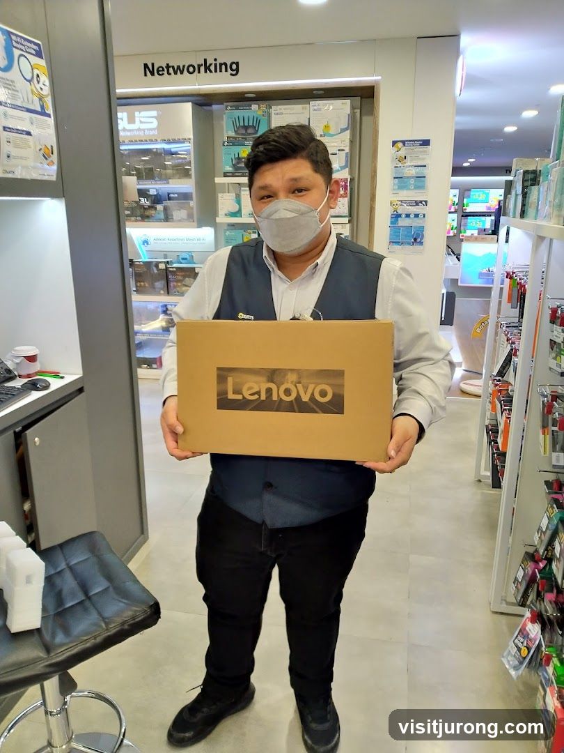 Salesperson holding a Lenovo laptop box