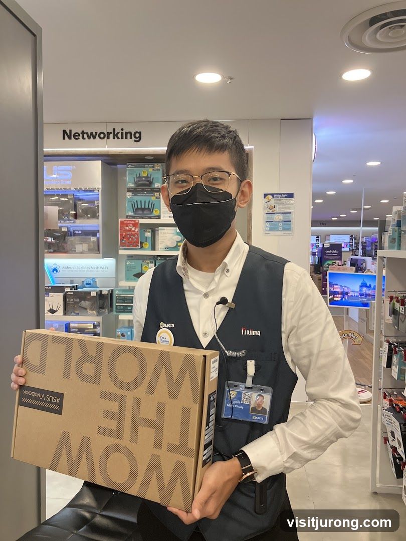 Sales Associate Holding Laptop Box