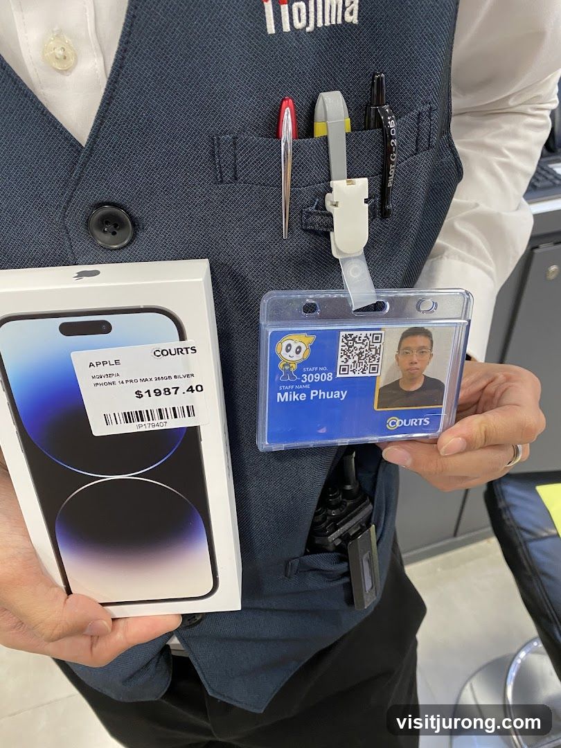 Employee holding an iPhone box and ID badge