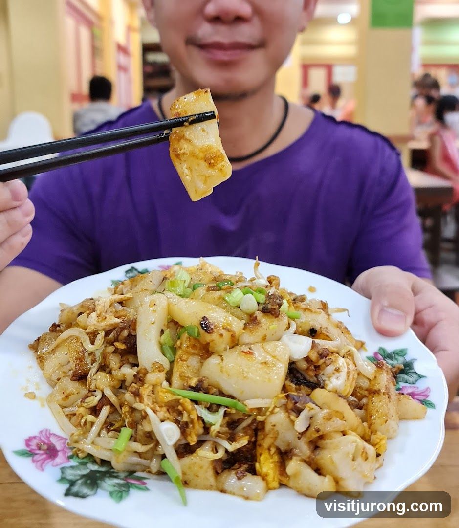 Person holding a plate of stir-fried rice cakes