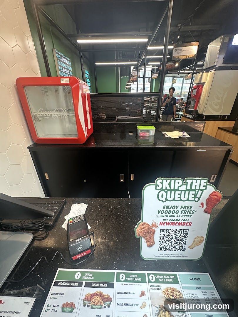 Menu and promotional sign at a restaurant counter