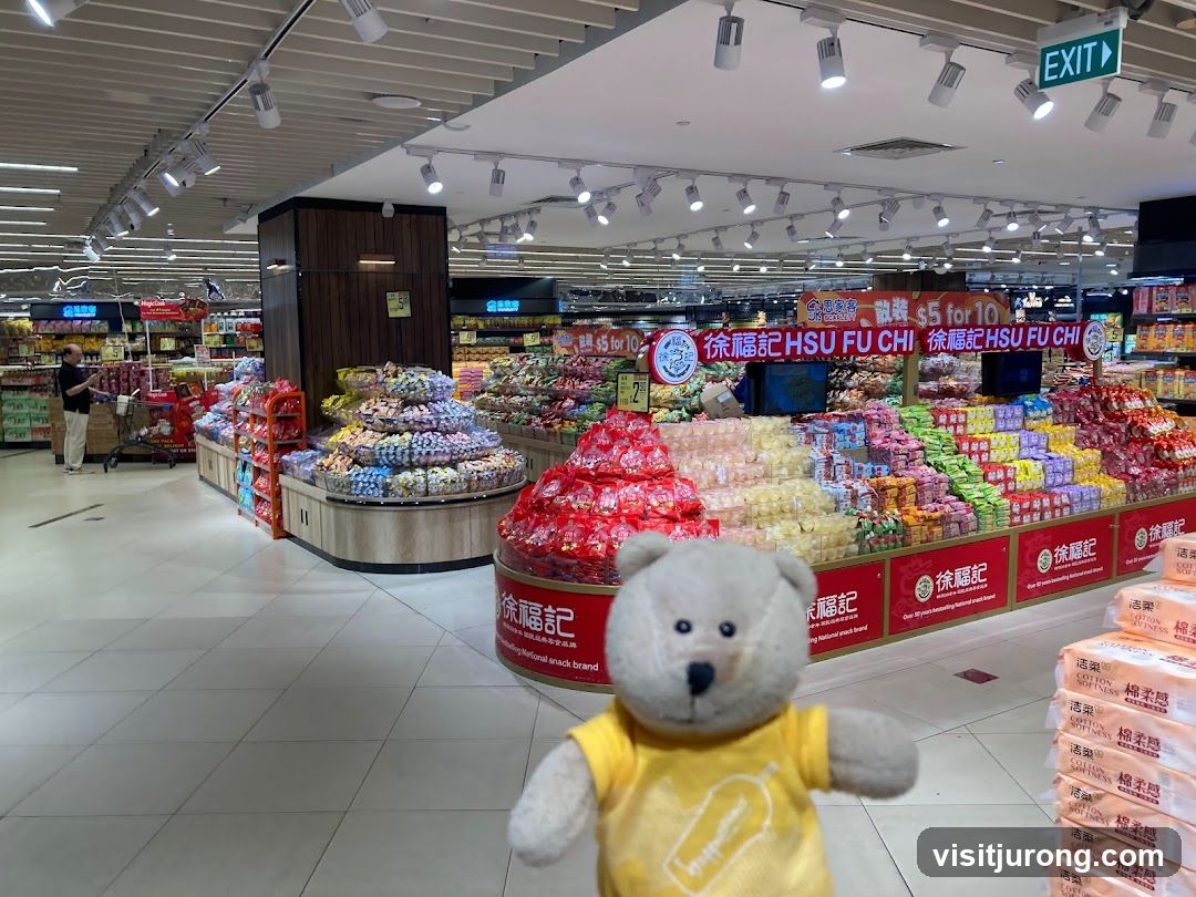 Supermarket aisle with snacks and a teddy bear
