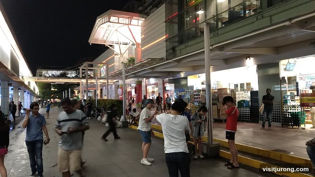 People walking in a shopping arcade at night