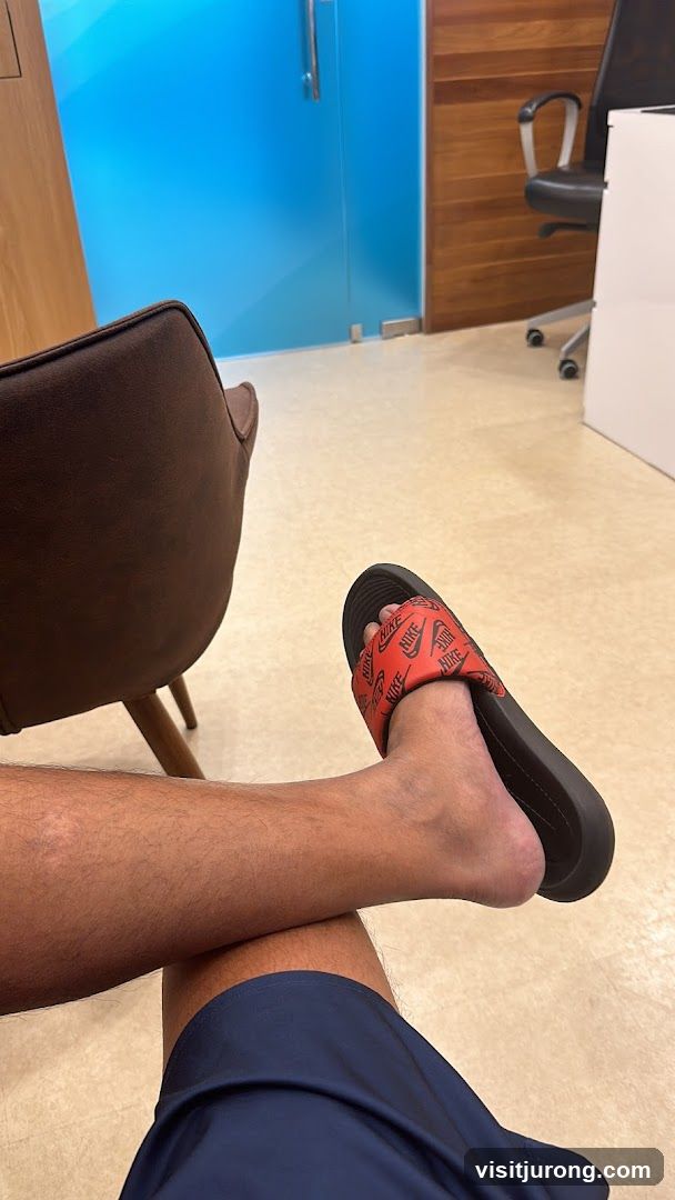 Person wearing Nike slides