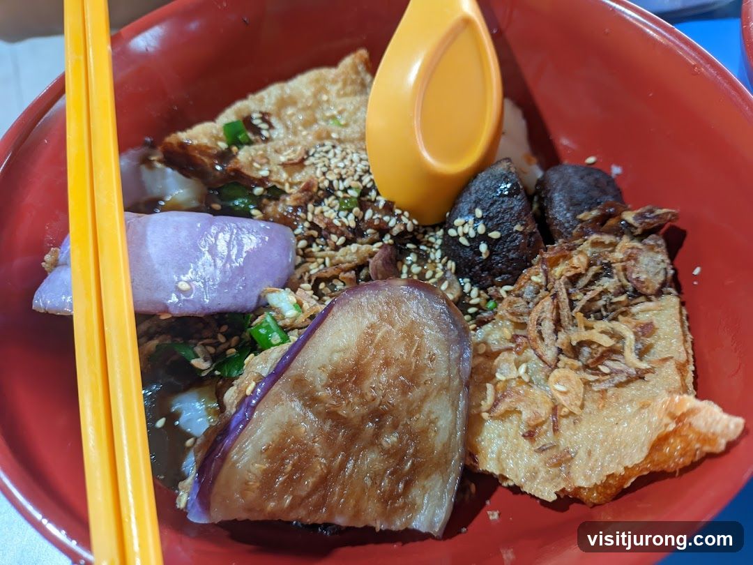Bowl of food with eggplant and other toppings