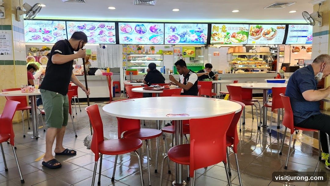 Food court interior with diners and staff
