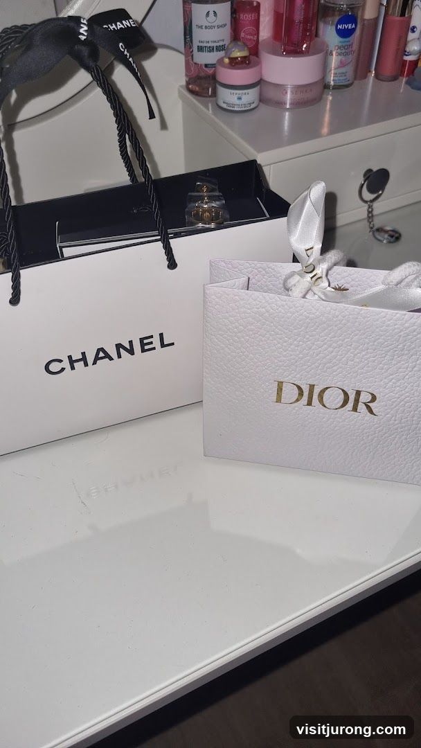 Chanel and Dior shopping bags with perfume
