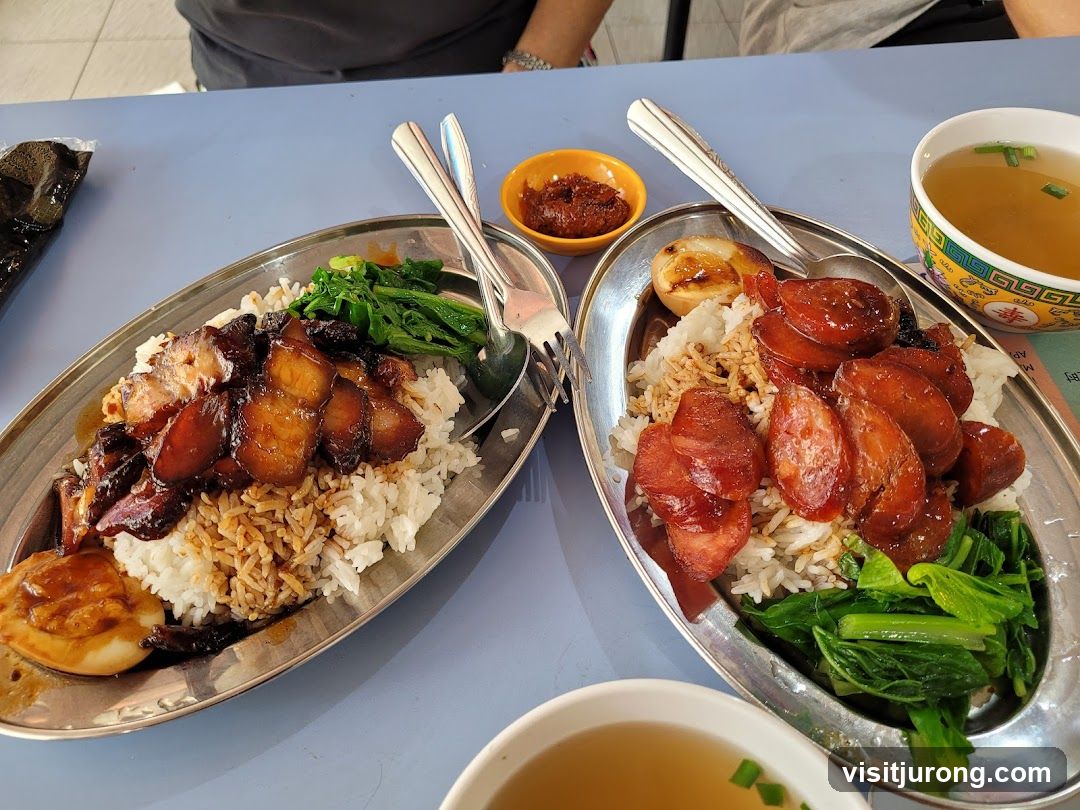 Two plates of rice with meat and vegetables