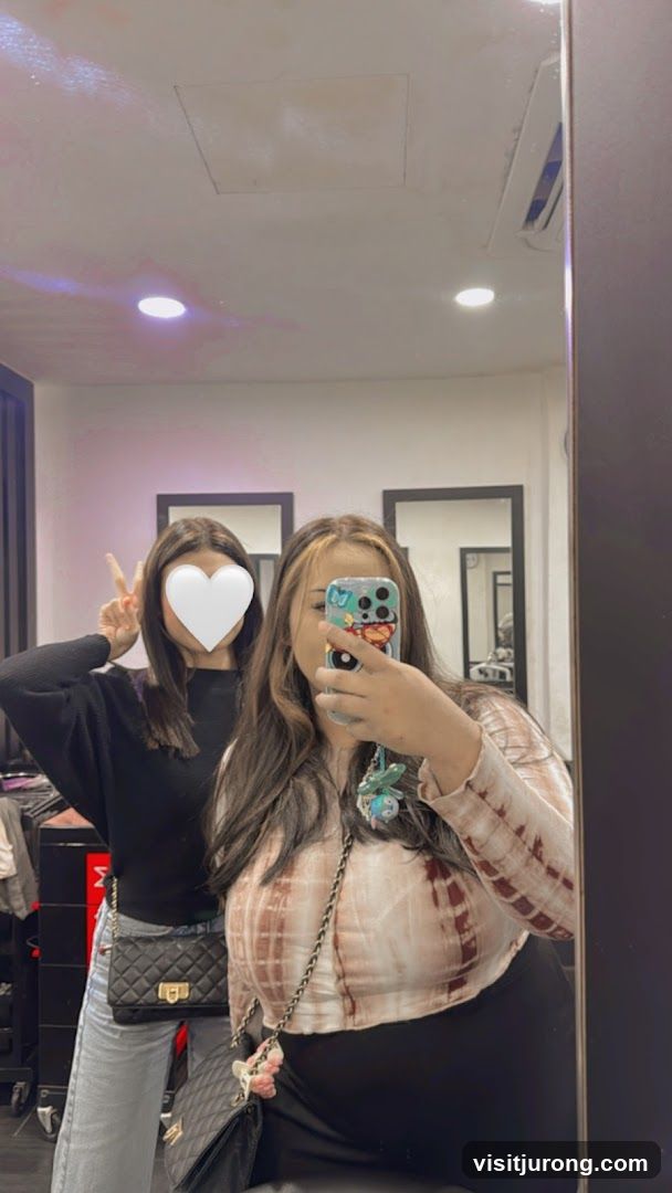 Two people taking a mirror selfie
