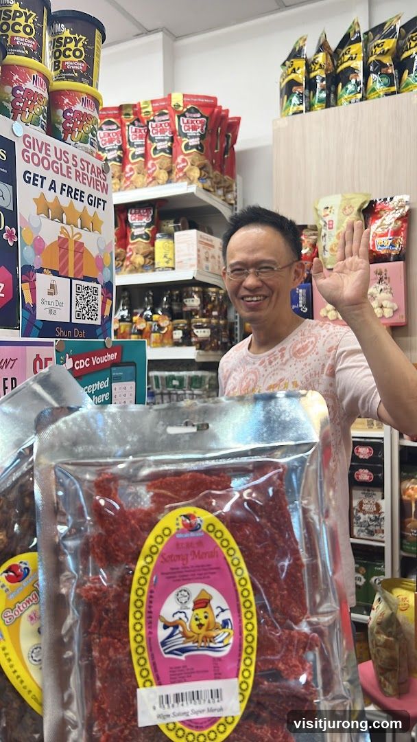 Man Waving in a Snack Shop