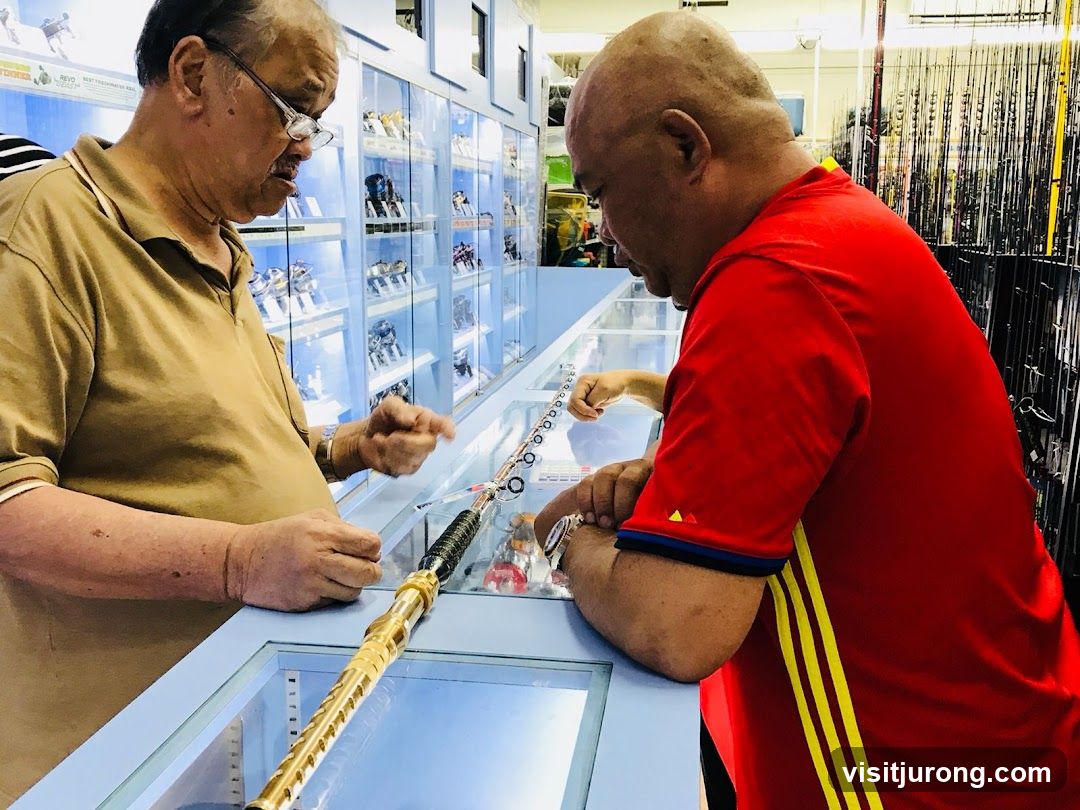 Two men examining fishing gear