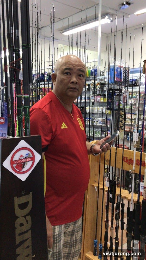 Man in Fishing Rod Store