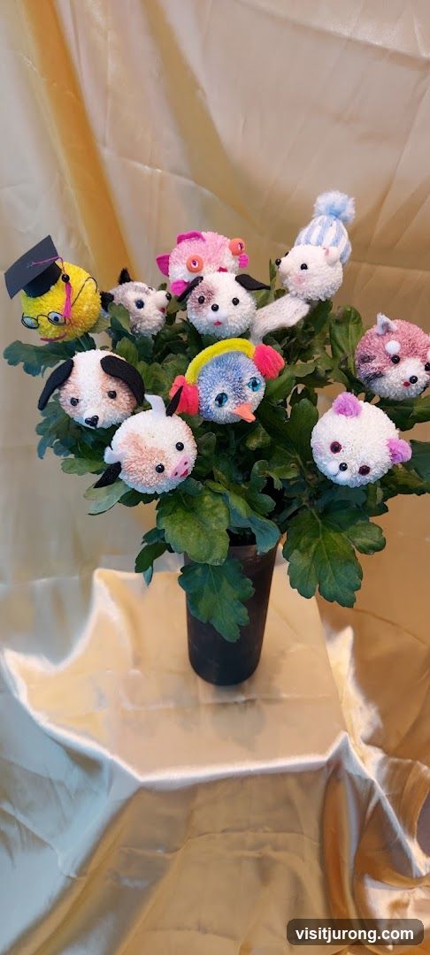 Pom-pom creatures in a plant pot