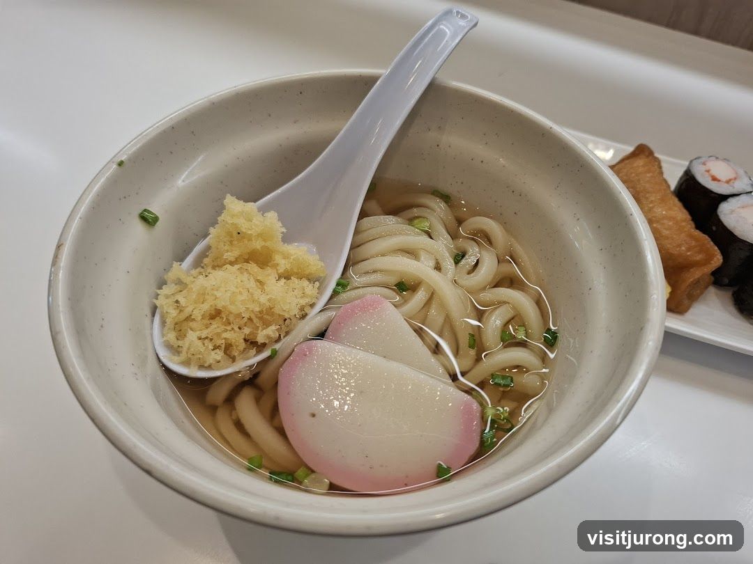 Udon Noodles with Tempura Bits and Sushi
